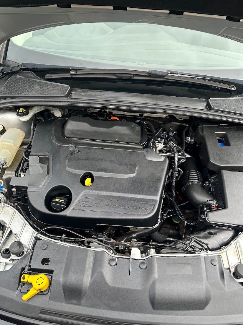 The same engine bay cleaned and dressed after a car deep clean